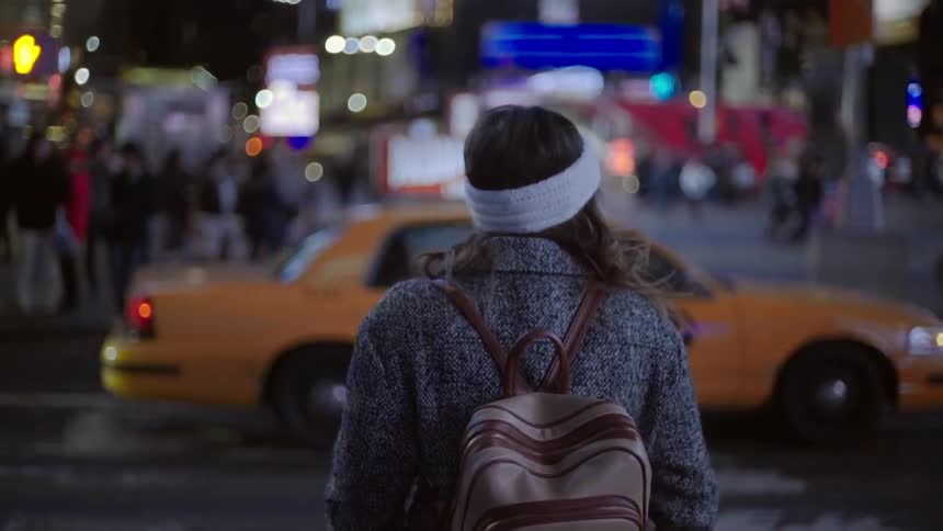 A woman is walking in a city