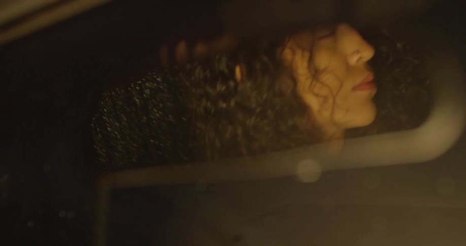 A woman drives a car in the rain