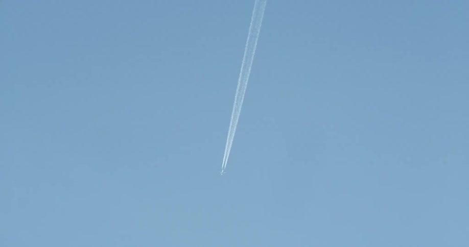 A jet flies in a clear sky