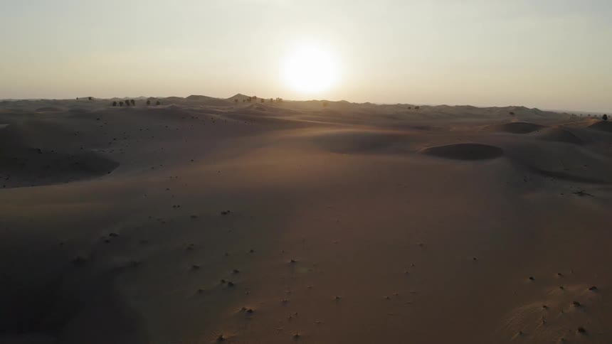 Sun shines over a hilly sandy desert