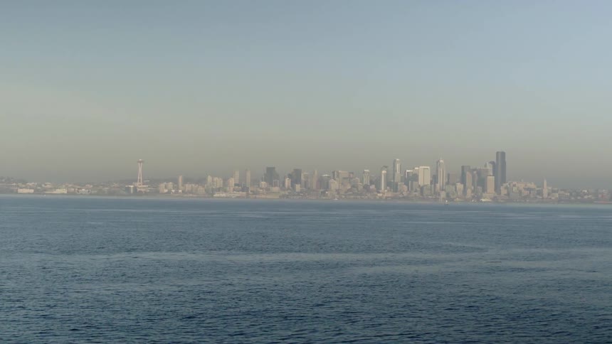 Smog is hanging over a coastal city on a sunny day