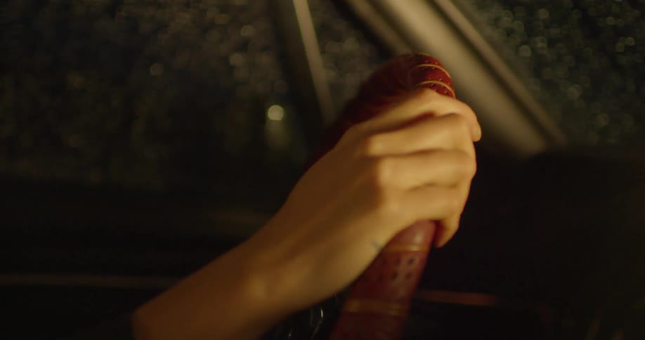 A driver takes their hand off the steering wheel