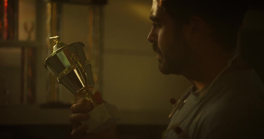 A man picks up a trophy