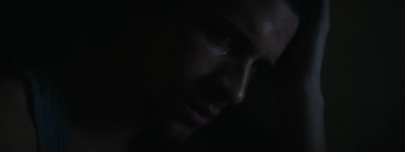 Lights flash around a worried looking man