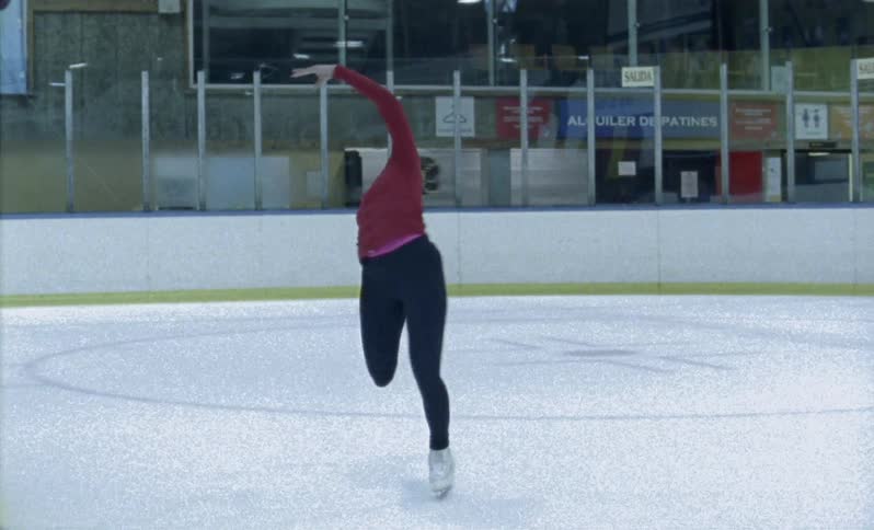 A figure skater spins on the ice