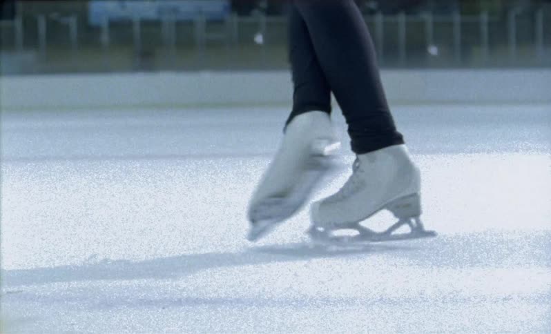 Ice skater is twirling on the ice