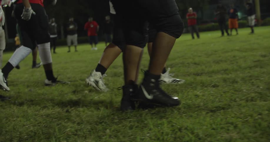 Football players walk on a field