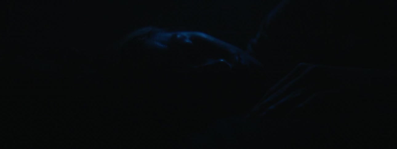 A man and woman cuddle while sleeping