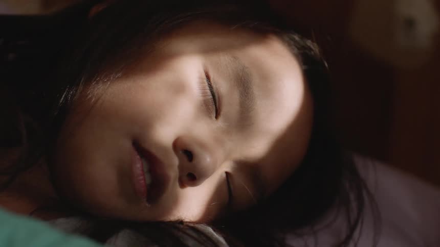 The girl is sleeping in the bed