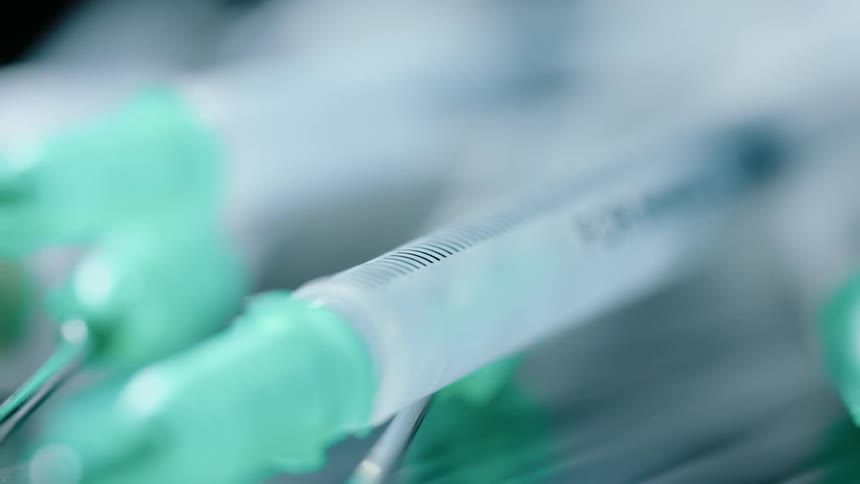 Syringes sit on a table