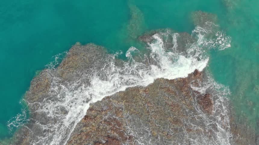 Water splashes over coral reef
