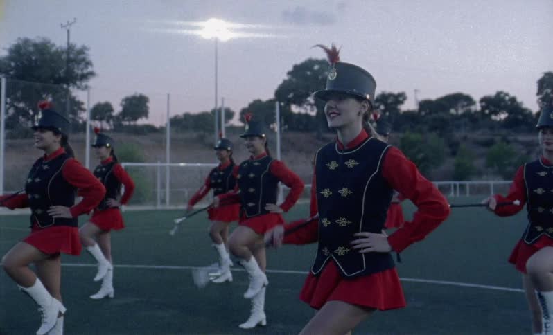 Group of majorettes march in place on a field