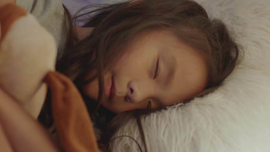 A girl lays down to go to sleep