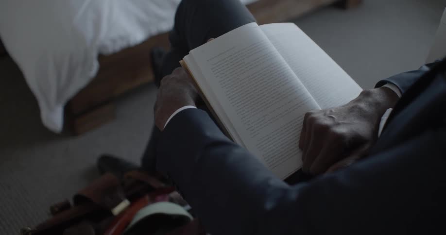 A man reads a book at home