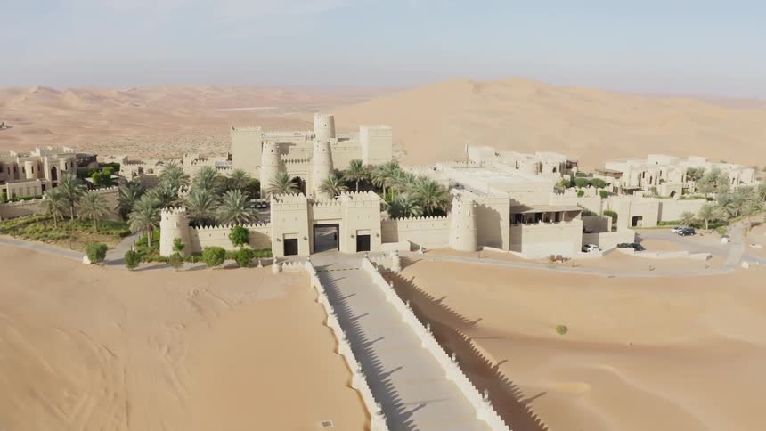 Buildings stand in the middle of a desert