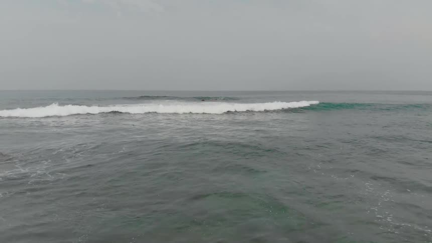Oceans waves curl and break as they come to shore