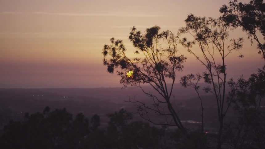 The sun sets over a valley