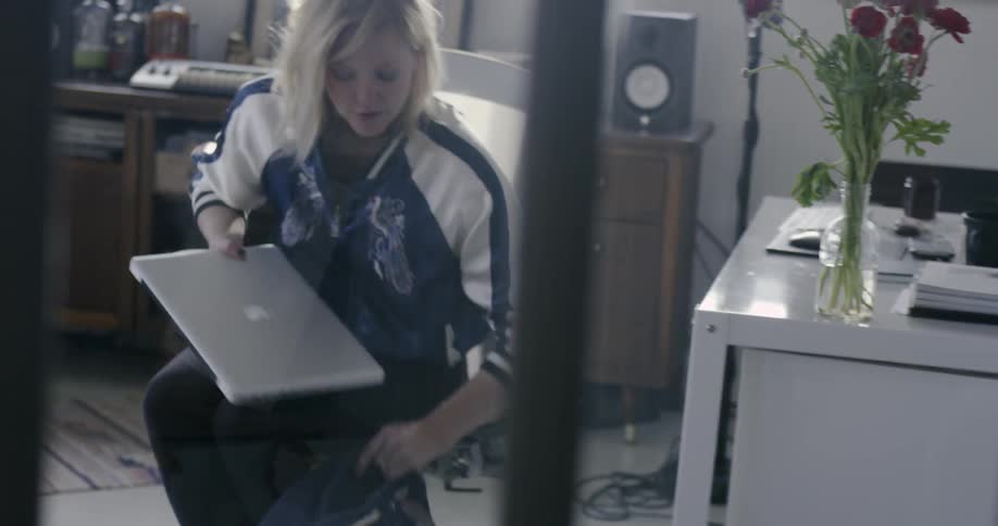 A woman puts her laptop into a backpack