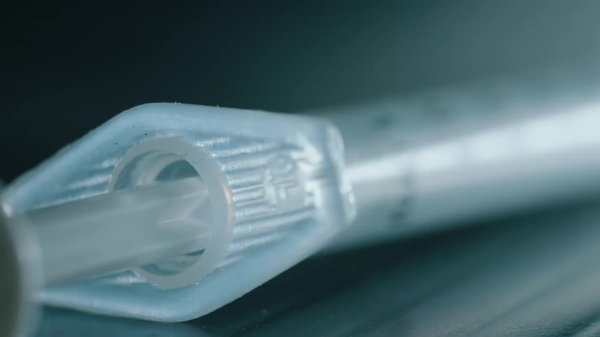 A syringe rests on a table