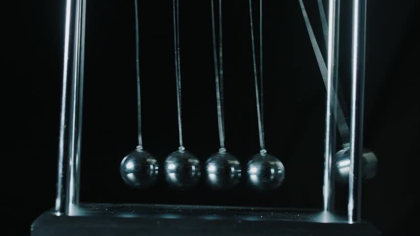 A newton's cradle is in motion