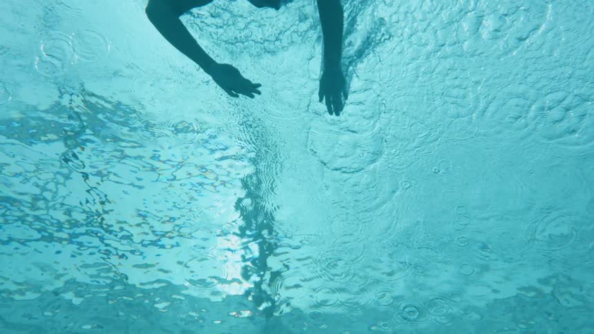 A woman swims in a pool