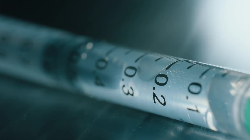 Liquid in a measured syringe forms a bubble