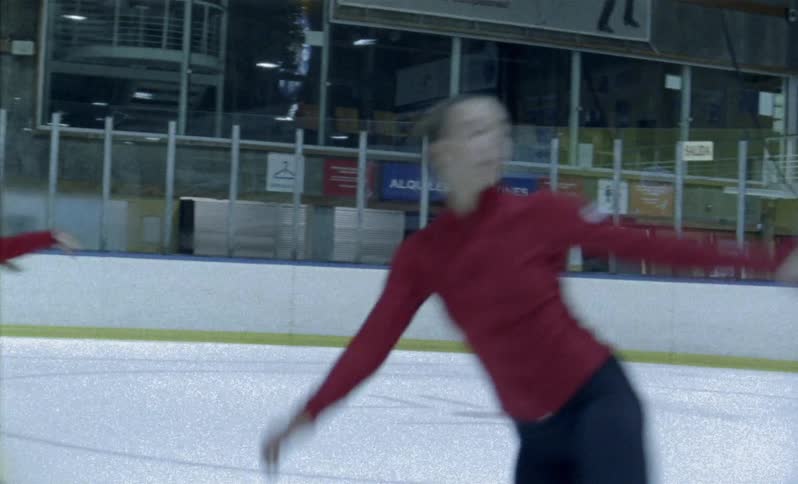 Figure skaters practice on the ice