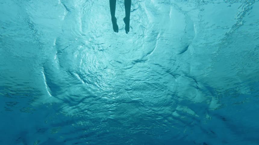 A man swims in a pool