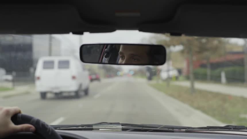 Man driving down a town road