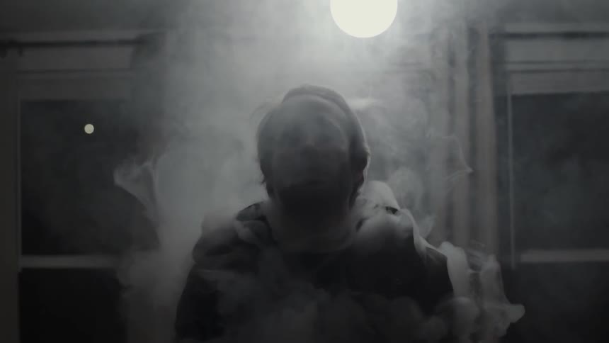 A man is covered in smoke