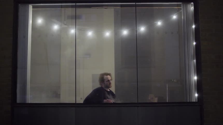 A person standing in front of a window