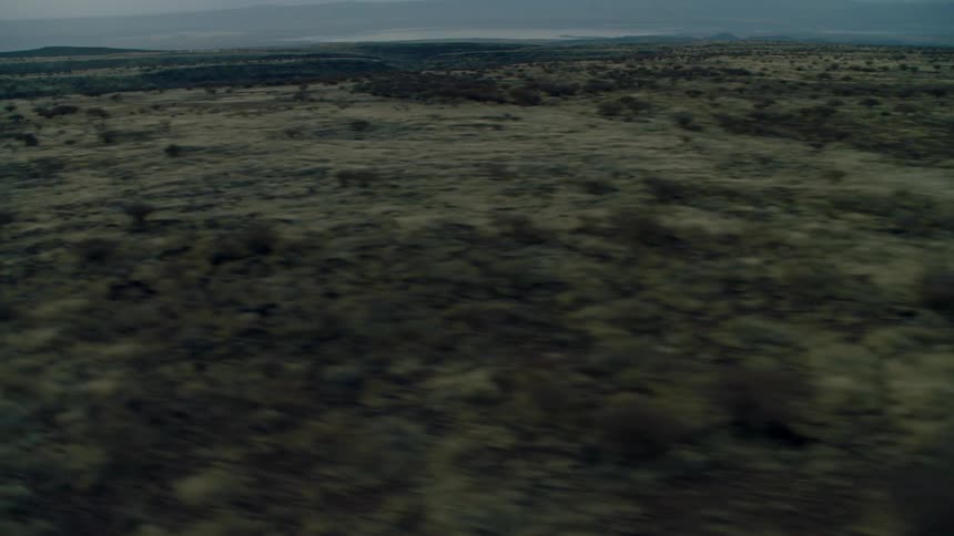 The green fields are empty on a cloudy day