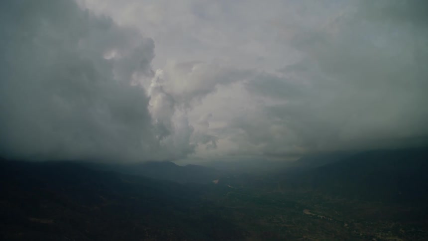 Clouds float above mountains