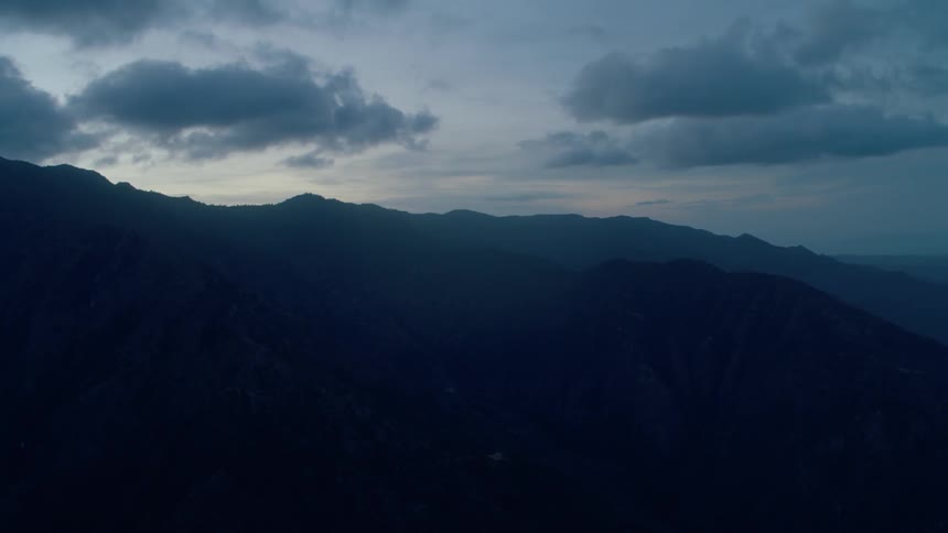 Sun sets over hilly land