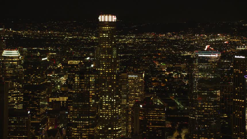 Large city with many skyscrapers lit up at night