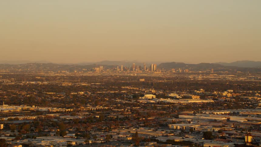 A cityscape is shown at sunset