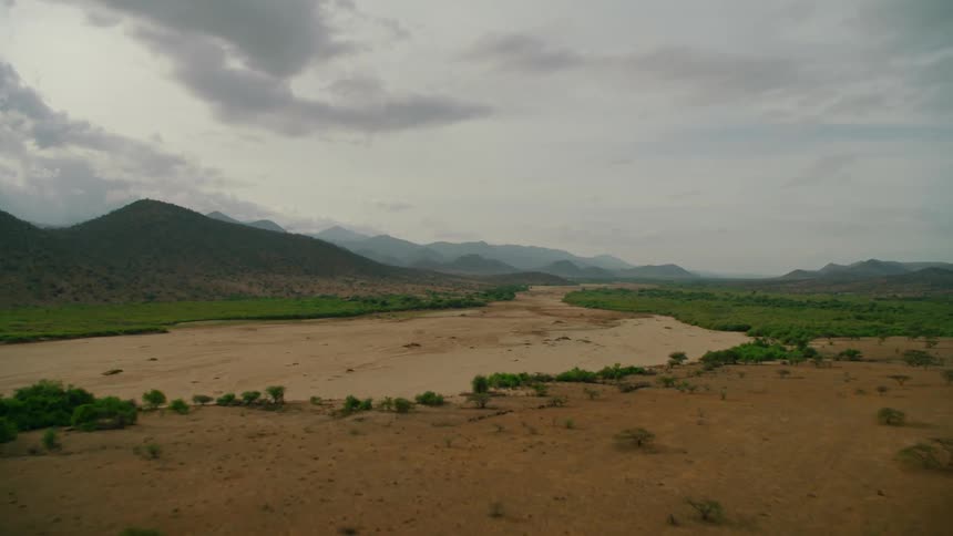 Clouds float above a rural mountain landscape
