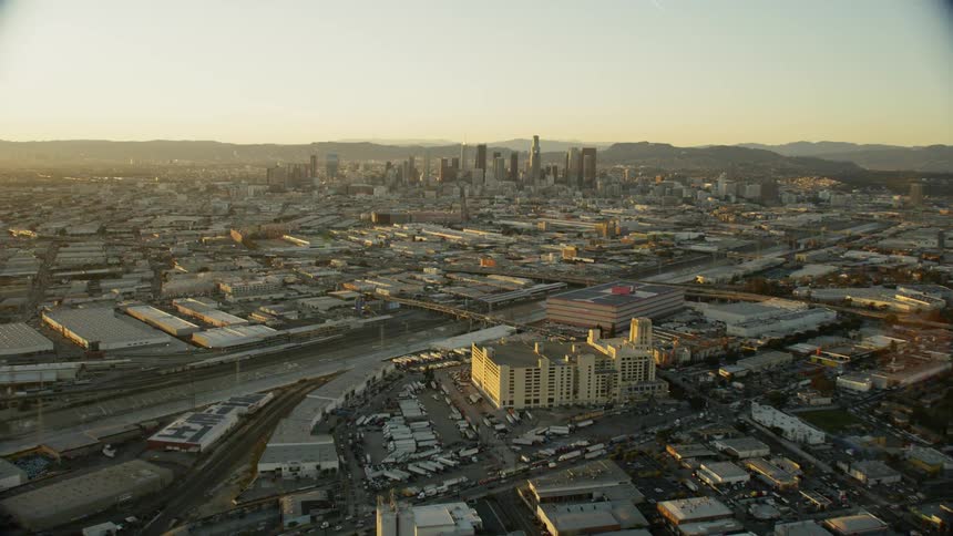 The sun sets over a cityscape; Los Angeles