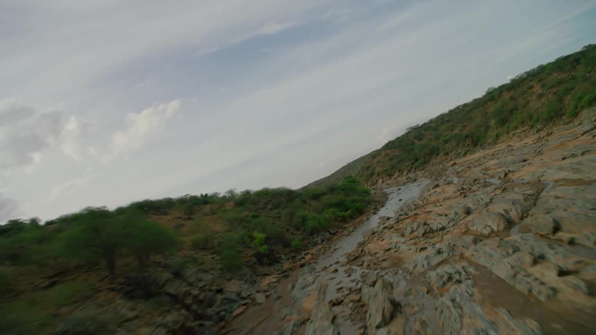 A muddy river winds through a landscape