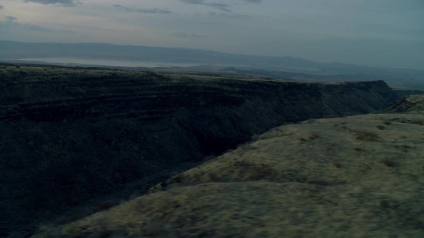 Clouds float above a rural landscape at sunset