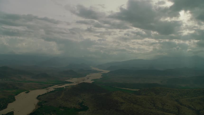 Grey clouds pass above the landscape