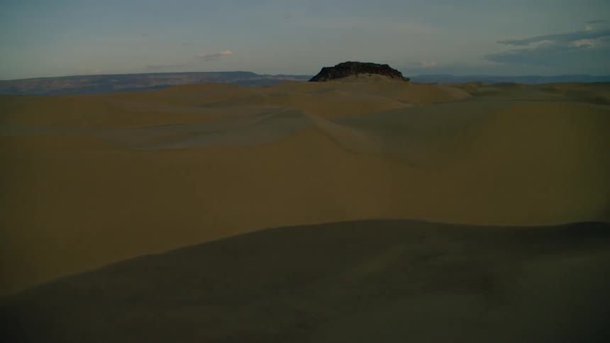 Sandy hilly desert at sunset