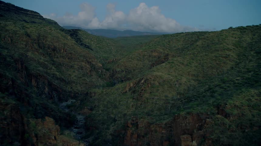 Clouds float above a mountain landscape