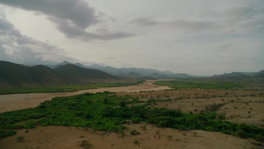 Clouds float above a rural mountain landscape