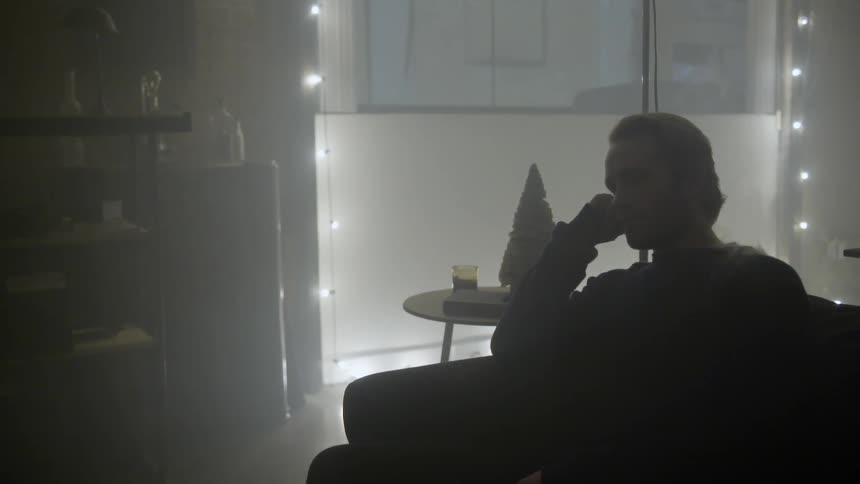 A man sits alone inside