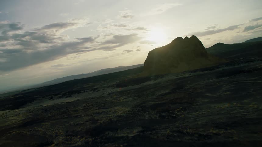 The sun sets over a mountain