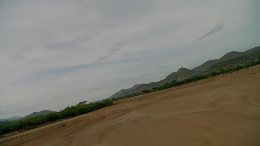 Clouds float above a rural mountain landscape