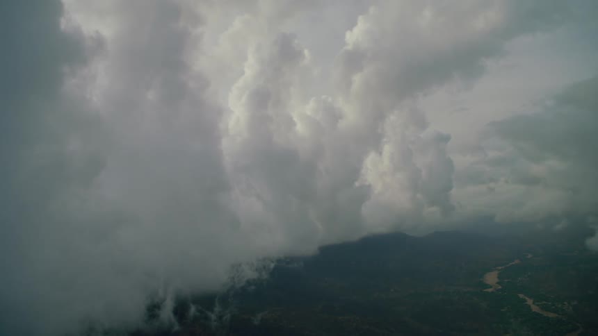 Clouds float over grassy plains