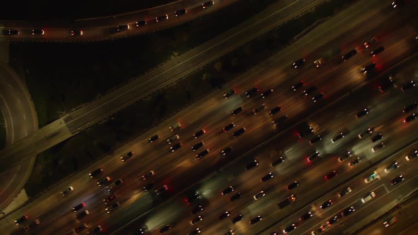 Vehicles travel on a highway at night