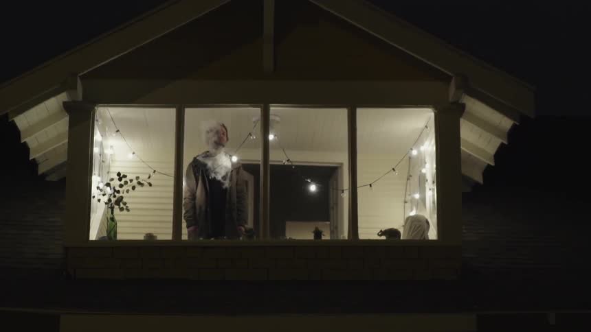 A person standing in front of a window